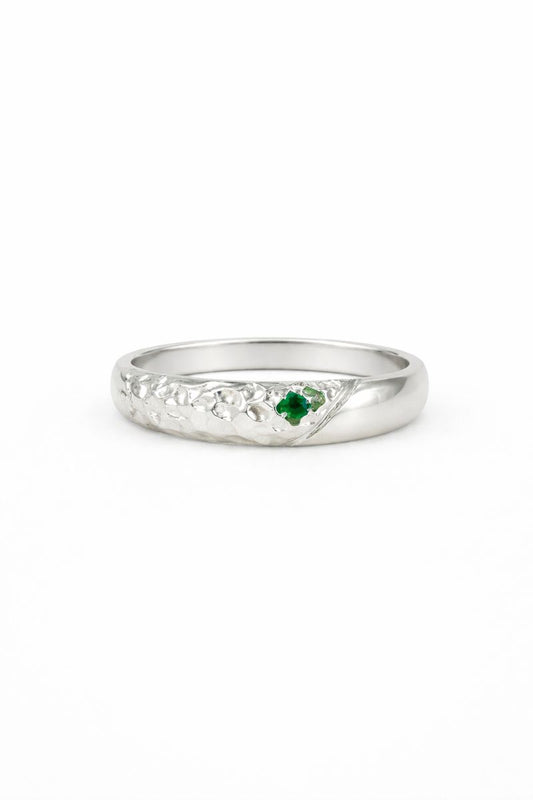 textured Silver ring with a green gemstone on a white background