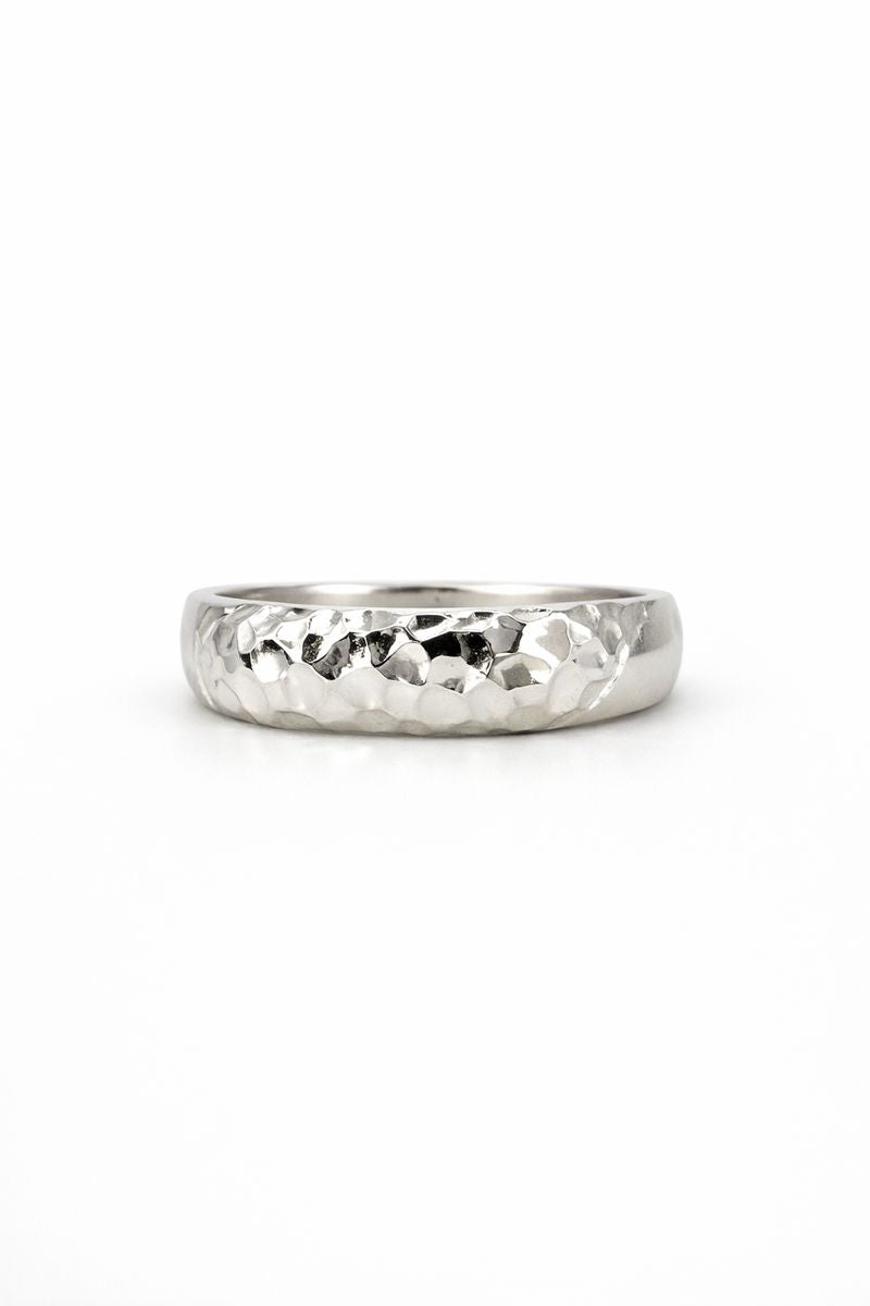Silver ring with a textured band on a white background