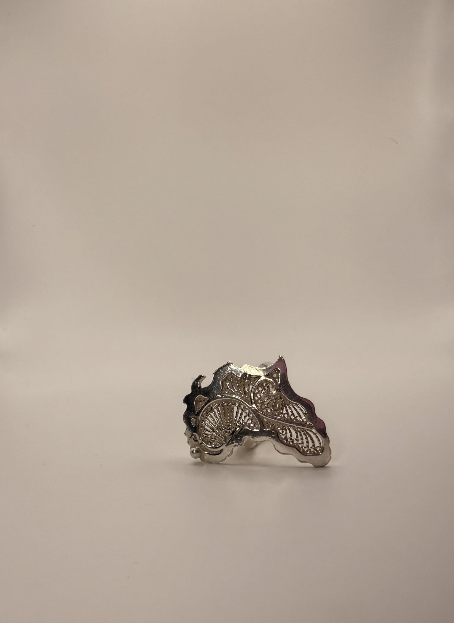Close-up of Doomi Afrik 925 silver statement ring with white background.