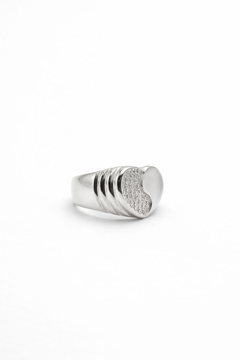 Silver ring with a textured band on a white background