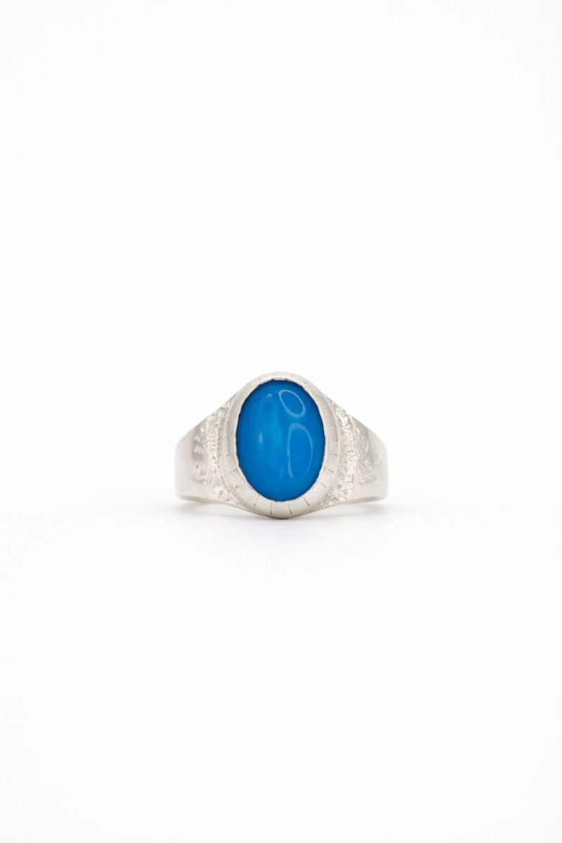 Silver ring with a blue stone on a white background