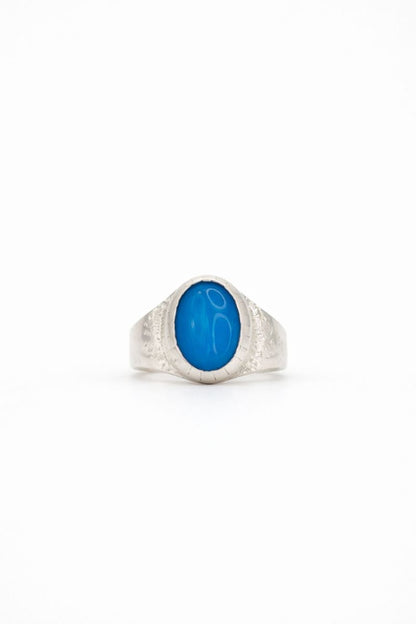 Silver ring with a blue stone on a white background