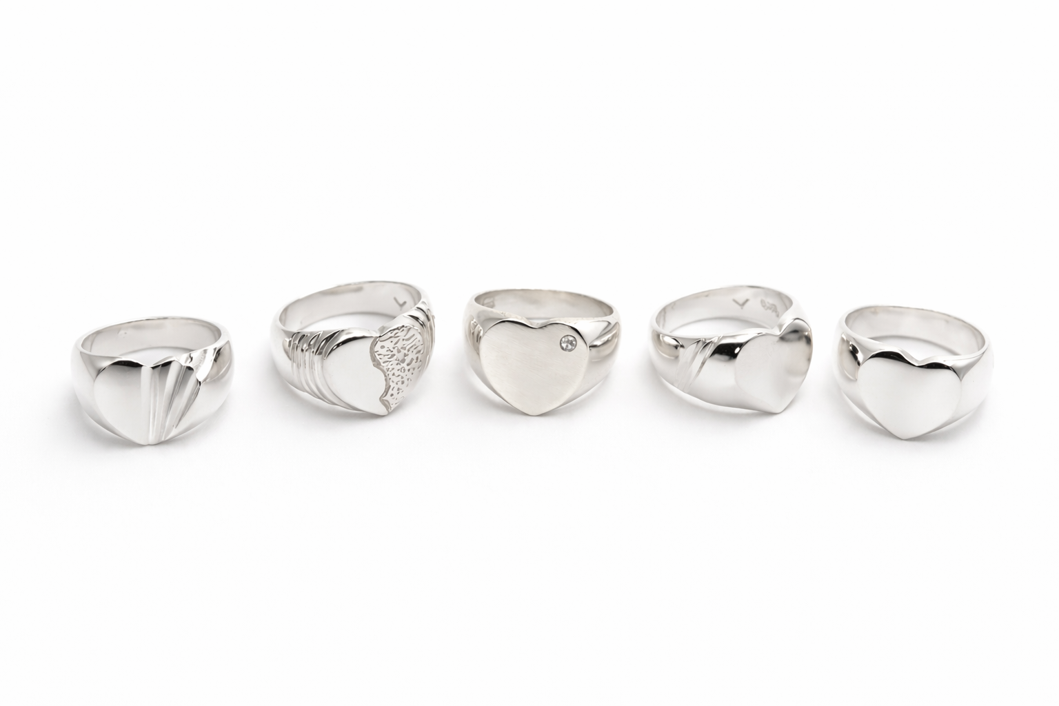 Sterling silver heart ring collection featuring polished, textured, and stone-set designs