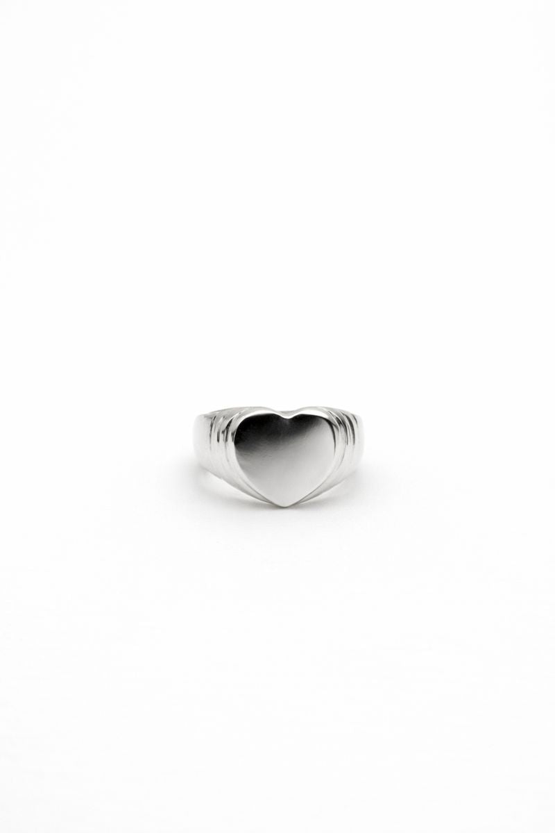 Polished sterling silver heart signet ring on a clean white background