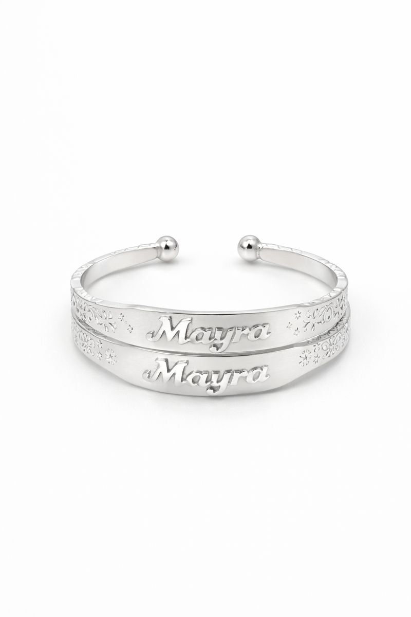 Silver bangle with 'Mayra' engraving on a white background