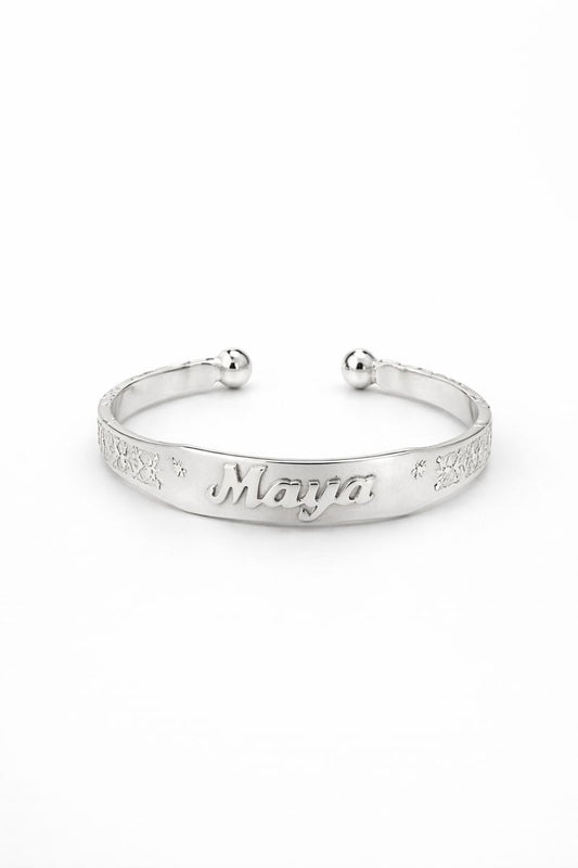 Silver bracelet with engraved text on a white background