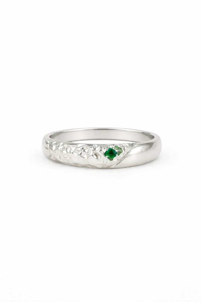 textured Silver ring with a green gemstone on a white background