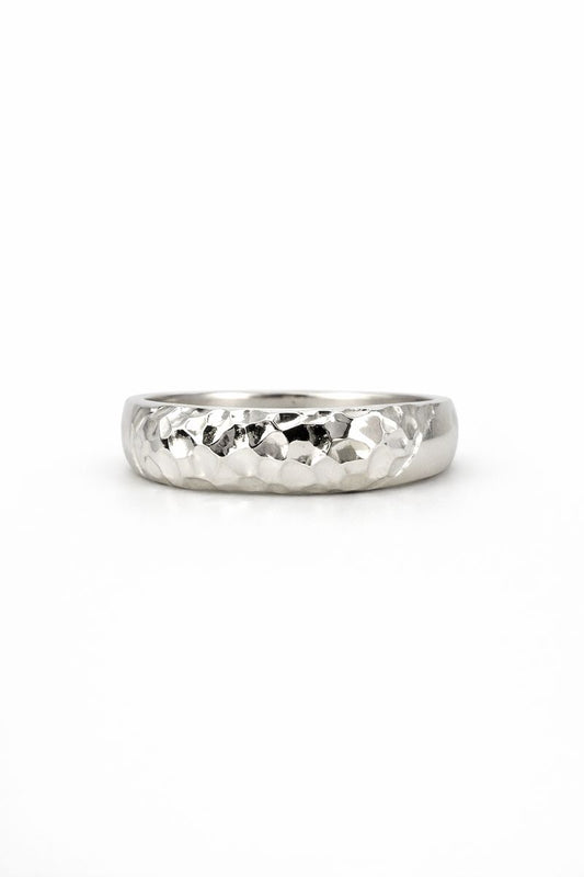 Silver ring with a textured band on a white background